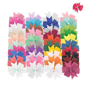 Close-up of colorful grosgrain ribbon bow clips set with metal alligator backing