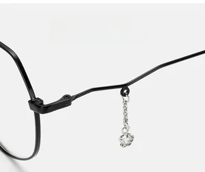 Close-up of durable metal hinge and decorative star pendant on black glasses frames