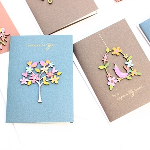 Detail of 3D pop-up greeting cards with wood flower motifs and handwritten blessings