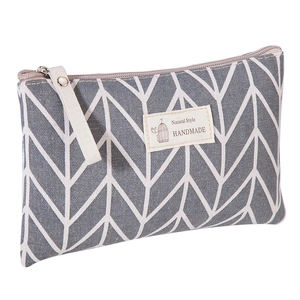 Large capacity gray chevron fabric makeup bag with handmade label and zipper closure