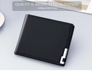 Detail of slim black bi-fold men's wallet with pebble grain leather and metal accent