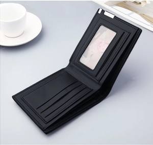 Macro shot of minimalist black leather wallet showing multiple card slots and photo window