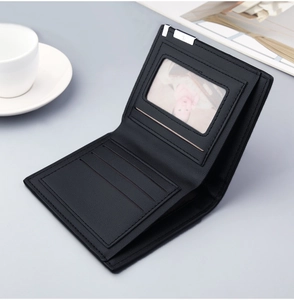 Detail of slim men's black leather bifold wallet with card slots and a photo window