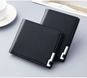 Close-up of black textured leather men's wallets with elegant silver corner details