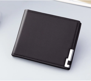 Detailed view of black leather bi-fold wallet with fine texture and silver metal hardware