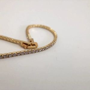 Elegant gold-plated tennis bracelet with white zircon stones and secure clasp
