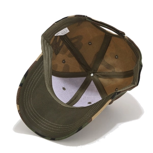 Inside view of camouflage baseball cap showing green trim and polyester material label