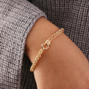 Minimalist gold chunky chain necklace with a unique geometric toggle clasp on a sweater
