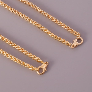 Detailed view of two gold woven chain necklaces featuring secure lobster clasps on gray background