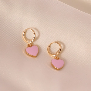 Chic pink heart drop earrings with gold metallic frames on soft silk background