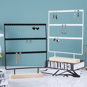 Three-tier iron jewelry stand with wooden base for earrings and necklaces in black and white