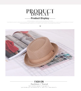 Detail of light brown woven fedora hat with breathable mesh and side metal ornament