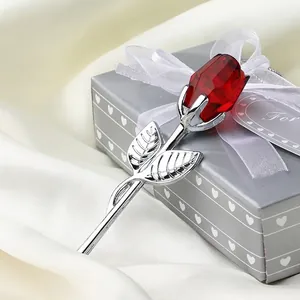 Close-up of a faceted red crystal rose resting on a premium gray heart-shaped gift box