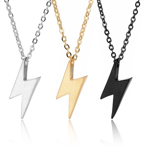 Detailed close-up of lightning bolt pendants in silver, gold, and black finishes with chains