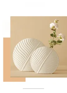 Detail of white ceramic leaf texture vase with matte finish in Nordic minimalist style