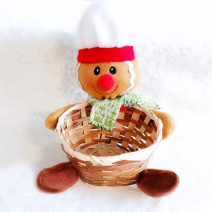 Detail view of a small bamboo Christmas basket featuring a cute plush gingerbread man figure