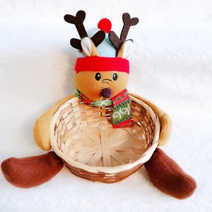 Detail view of a reindeer plush bamboo Christmas storage basket with knit scarf accents