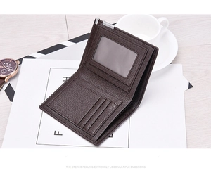 Close-up of brown lychee grain leather bifold wallet with card slots on white background