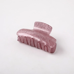Detail view of pinkish-purple hair claw clip with unique marble texture finish