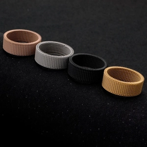 Macro shot of flexible titanium steel mesh rings in copper, silver, black, and gold colors