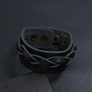 Close-up of black braided leather bracelet with three antique bronze snap fasteners