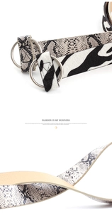 Detail of zebra and snakeskin pattern belts with silver double ring buckles for women