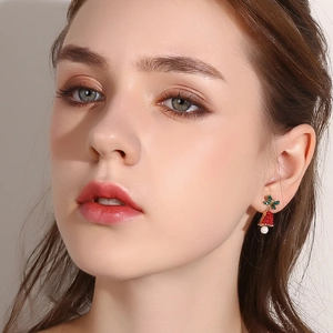 Christmas bow bell earrings with pearls shown on a female model for festive style