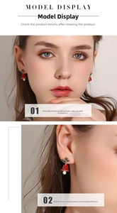 Detail of Christmas bow bell earrings with red rhinestones and white pearl drops