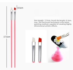 Detail of two angled nail art brushes with 17.5cm pink handles and 0.5cm nylon bristles