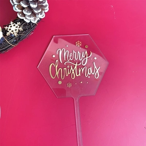 Hexagon red acrylic cake topper with golden Merry Christmas and snowflake patterns