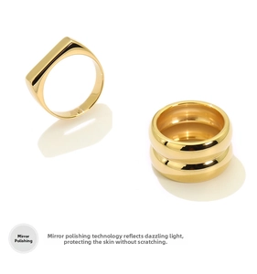 Close-up of polished 18K gold plated chunky stainless steel square and double rings