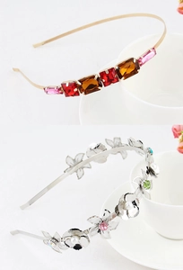 Detail of alloy headbands featuring colorful gemstones and delicate faux pearls