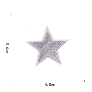 Detail of a 5cm silver star embroidered patch showing fine needlework and stitching