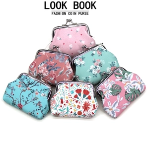 Close-up of assorted floral canvas coin purses with vintage metal kiss lock clasps