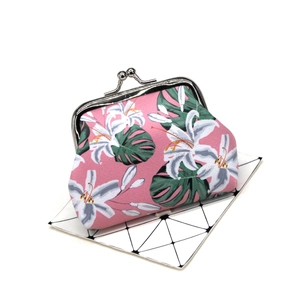 Detail of vintage floral coin purse with silver metal clasp and lily flower pattern