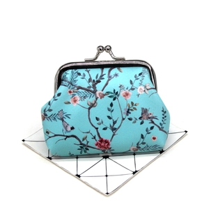Detail of floral and bird print coin purse with a vintage silver metal kiss-lock clasp