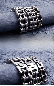 Detail of stainless steel motorcycle chain bracelet showing industrial texture and finish