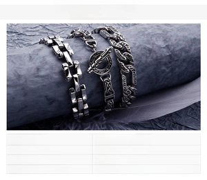 Detailed view of three vintage punk stainless steel men's bracelets with ornate patterns