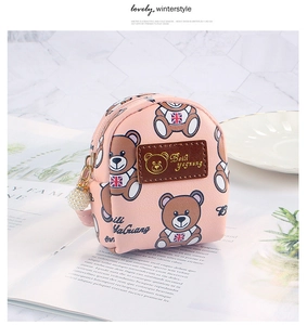 Detailed view of pink mini bear coin purse with gold logo and pearl charm accessory
