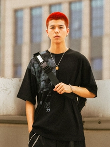 Close-up of a hip hop square pendant necklace paired with a trendy black streetwear T-shirt