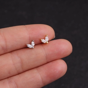 Marquise cut zircon stainless steel stud earrings in gold and silver finish on hand