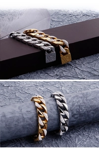 Detail of gold and silver cuban link bracelets with rhinestone inlay and embossed clasp