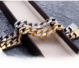 Macro shot of gold and silver cuban link chains with white zircon pavé on jewelry box