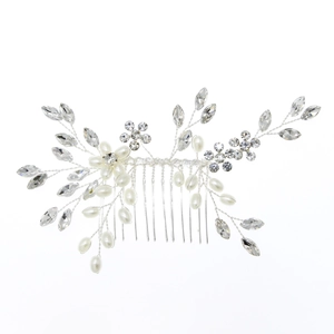 Detail of silver bridal hair comb featuring handmade pearls, crystals and floral metal leaves