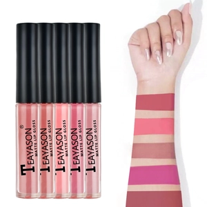 Arm swatches of five matte lip gloss shades in nude and pumpkin tones on skin