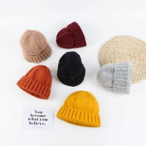 Winter knitted beanies in multiple colors with ribbed cuff on minimalist white background