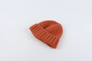 Detail of orange ribbed knit texture and soft warm material on this winter beanie
