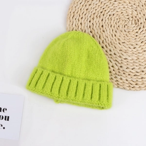 Detailed view of neon green knitted beanie with wide cuff and ribbed texture