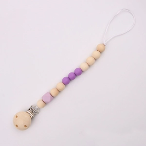 Detail of baby pacifier clip with purple silicone beads and natural wooden beads