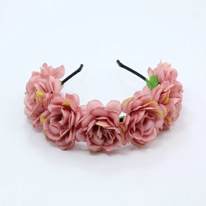 Detailed view of handmade pink fabric rose headband with a slim black metal frame